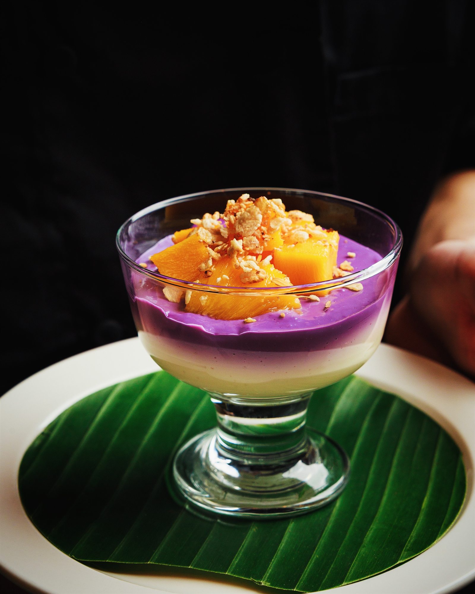 Layered ube pudding topped with mango and toasted crumble at Mina's Table
