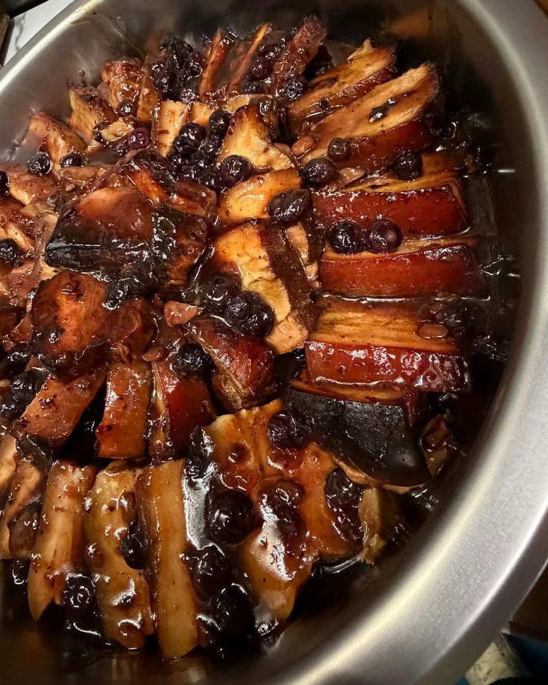 Slow-cooked pork belly glazed in Mina's homemade blueberry glaze, plated at Mina's Table